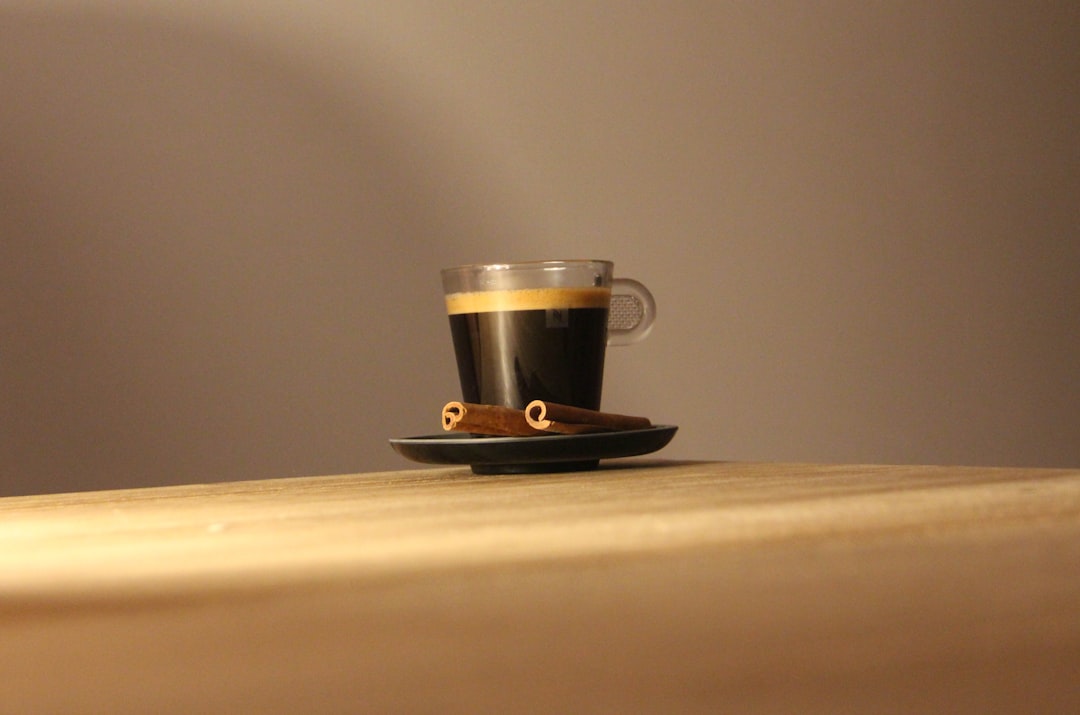black-and-white-ceramic-mug-on-brown-wooden-table-jabzl49jnuo