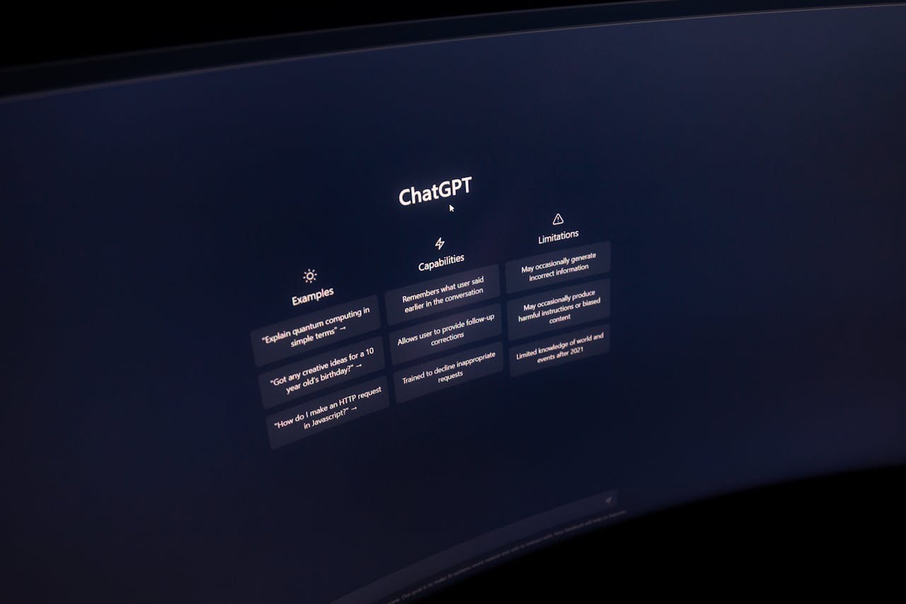 contact-img Close-up of a computer screen displaying ChatGPT interface in a dark setting.
