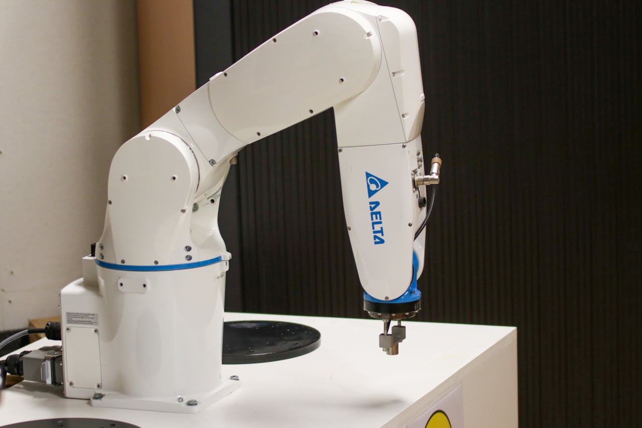 about-01 Close-up of a Delta brand robotic arm in an industrial setting, showcasing automation technology.